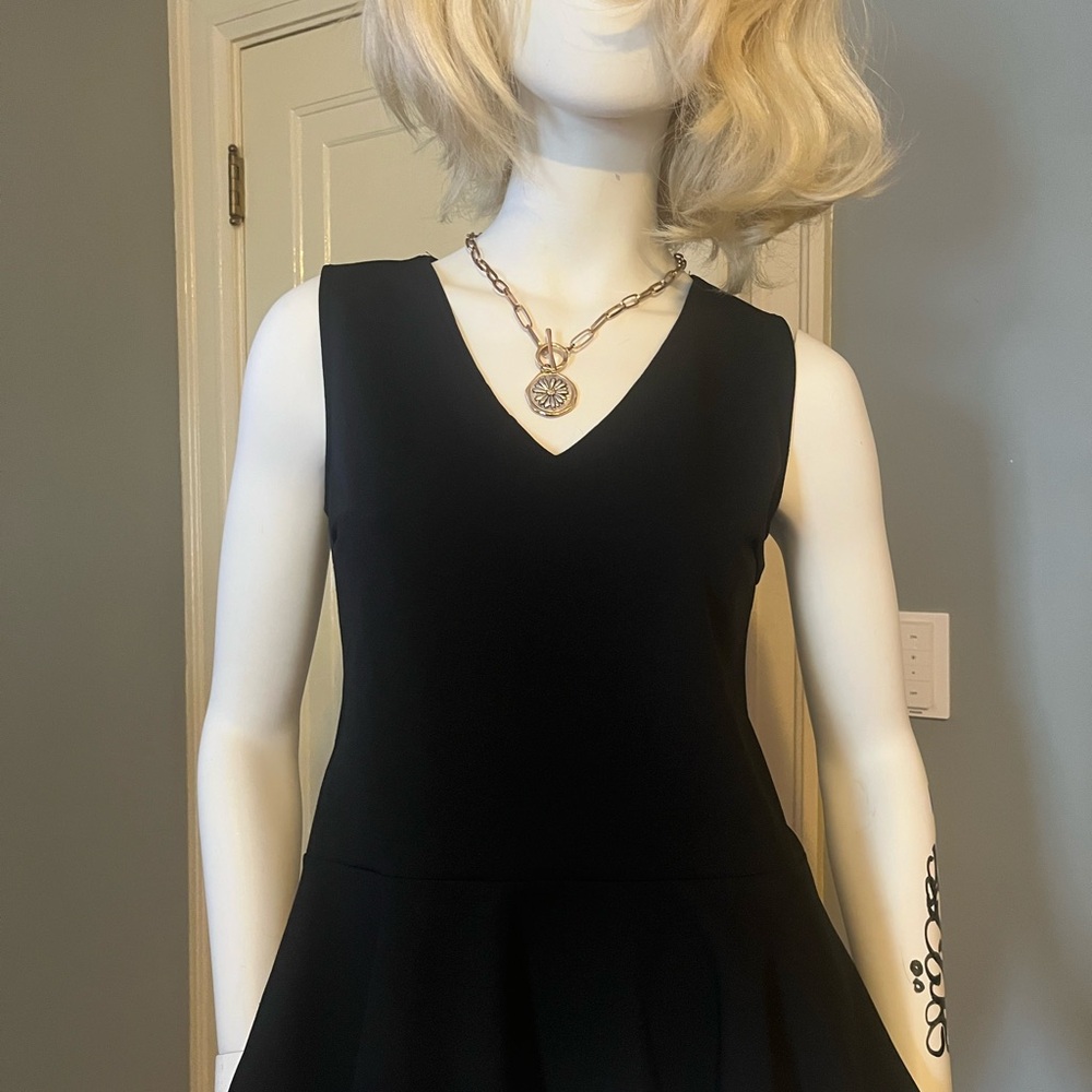Black sleeveless peplum top